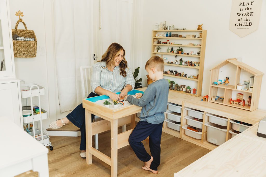 task42 A woman and boy playing with toys on a table.